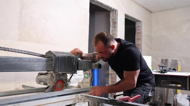 Construction Worker Using Tile Saw Cutting Ceramic Tiles