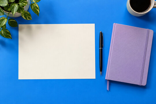 Blank paper with pen and lavender notebook on bright blue desk