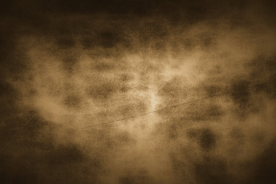 Aged brown grunge texture with subtle cloud motifs and faint linear scratches suitable for vintage themed design projects or classic artistic backgrounds.