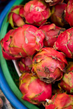 basket of dragon fruit in a market
