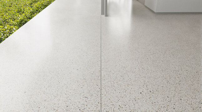 Architectural detail showcasing continuous terrazzo flooring extending from interior living space onto outdoor tropical deck with hidden thermal break