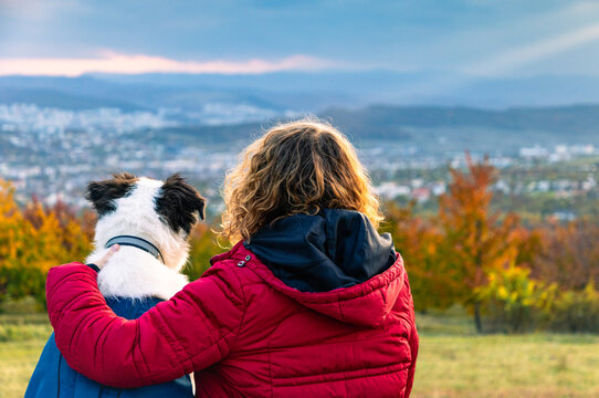 happy woman with dog enjoying autumn outdoors