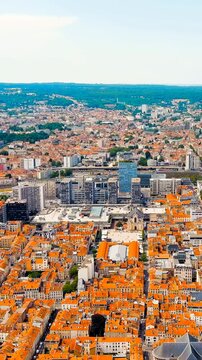 Vertical video. Nancy, France. the UNESCO-listed Place Stanislas and the city's terracotta rooftops, revealing the neoclassical square, modern Tour Thiers, and the railway district under bright summe