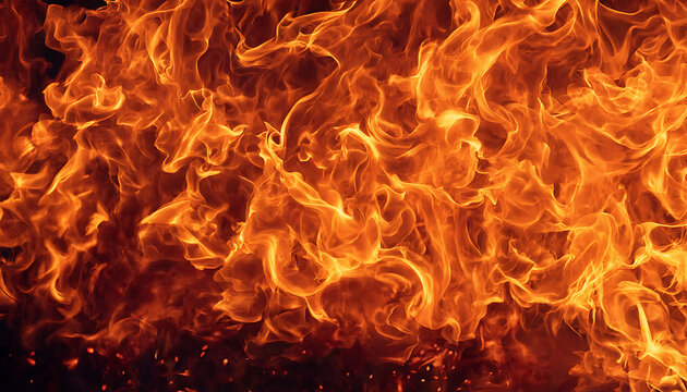 Intense blaze of raging orange fire flames on a dark background with blazing fire