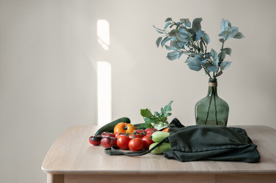 Fall vegetables on table, woven shopping bag on home kitchen table, food market shopping