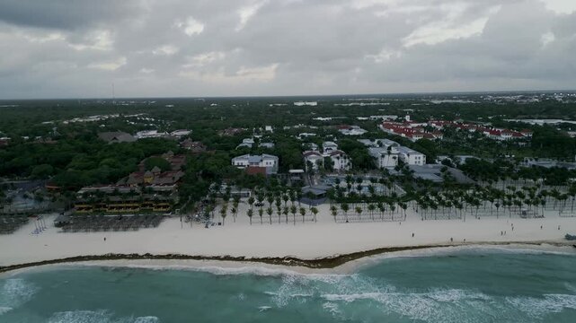 Aerial view of a resort coastline lined with drifting sargassum seaweed