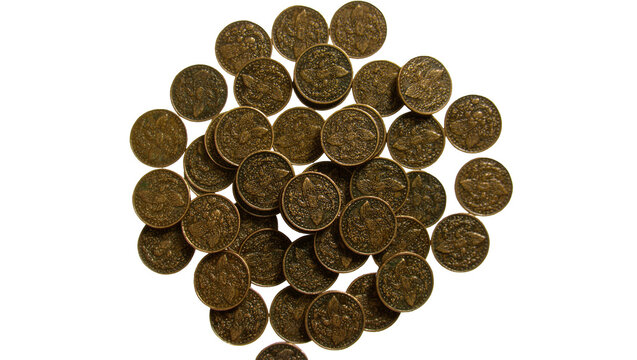 Pile of antique bronze coins with fleur-de-lis emblem, isolated on transparent background