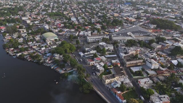 High-angle aerial panorama over a densely populated city waterfront and surrounding neighborhoods