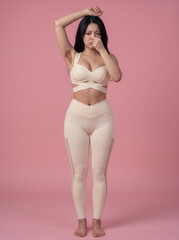Fototapeta premium Full body portrait of woman in beige activewear