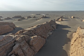 Yadan National Geopark near Dunhuang, Gansu, China, features dramatic wind-eroded rock formations rising from the Gobi Desert. A striking landscape along the ancient Silk Road. © JEREMIE