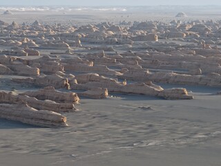 Yadan National Geopark near Dunhuang, Gansu, China, features dramatic wind-eroded rock formations rising from the Gobi Desert. A striking landscape along the ancient Silk Road. © JEREMIE