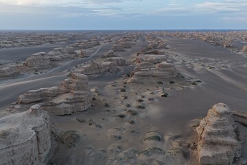 Yadan National Geopark near Dunhuang, Gansu, China, features dramatic wind-eroded rock formations rising from the Gobi Desert. A striking landscape along the ancient Silk Road. © JEREMIE