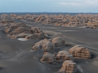 Yadan National Geopark near Dunhuang, Gansu, China, features dramatic wind-eroded rock formations rising from the Gobi Desert. A striking landscape along the ancient Silk Road. © JEREMIE