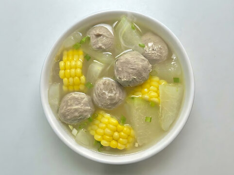 Bowl of healthy soup with meat balls corn and winter melon in clear broth
