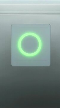 Glowing green ring interface on metallic panel surface displaying status indicator