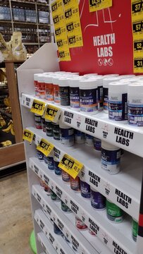 ITABIRA, BRAZIL - SEPTEMBER 15, 2026: Health Labs dietary supplements and vitamins display stand in a supermarket health and wellness product aisle.
