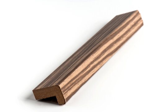 Studio photograph of an L-shaped decorative molding profile featuring a brown wood-effect finish and textured surface. 