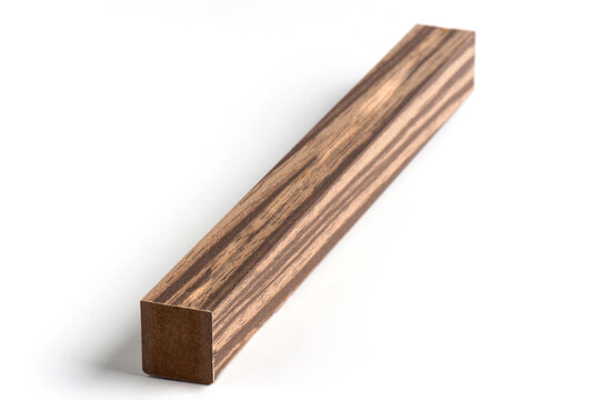 Studio photograph of a rectangular molding profile with a warm wood-effect finish and visible grain texture. 
