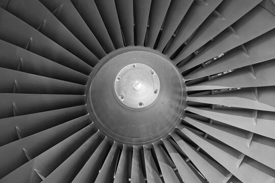 Close-up detail of a modern aircraft jet engine fan blades, aerospace technology and engineering.