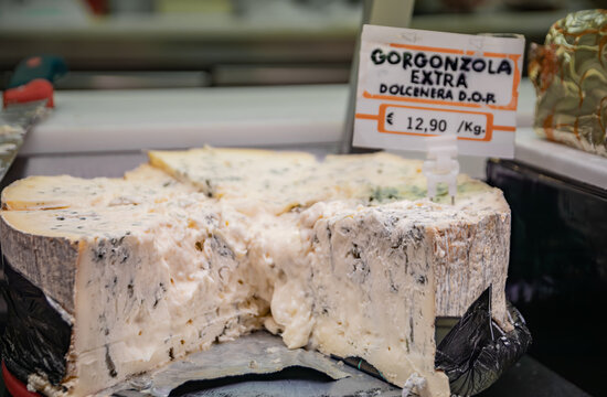 Gorgonzola cheese wheel at a farmers market cheese monger in Ventimiglia, Italy