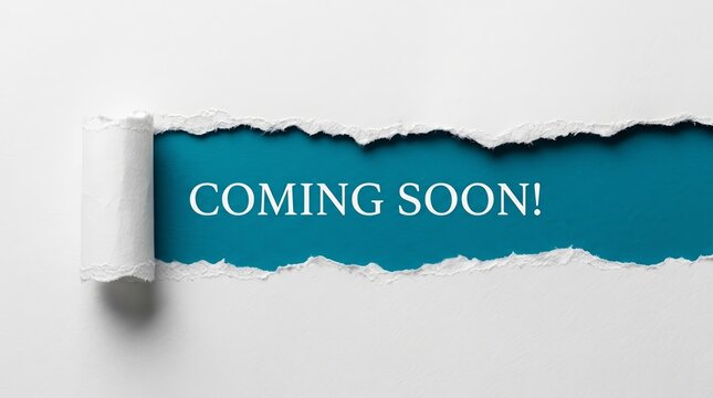 Creative announcement concept featuring coming soon message behind torn white paper.