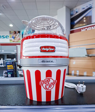 Denia, Spain - October 10, 2025. Red and white Ariete Party Time retro popcorn maker on shelf in retail store in Spain