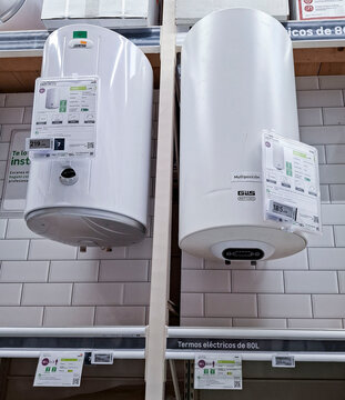 Denia, Spain - October 10, 2025. Vertical electric water heaters by Cointra and GTS mounted on a tile wall in a store in Spain