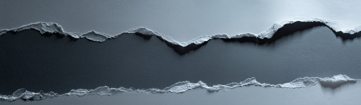 Ripped gray paper edges revealing dark background centered horizontal banner copy space studio shot text message framing design element template mockup background 2026 header layout structure paper.