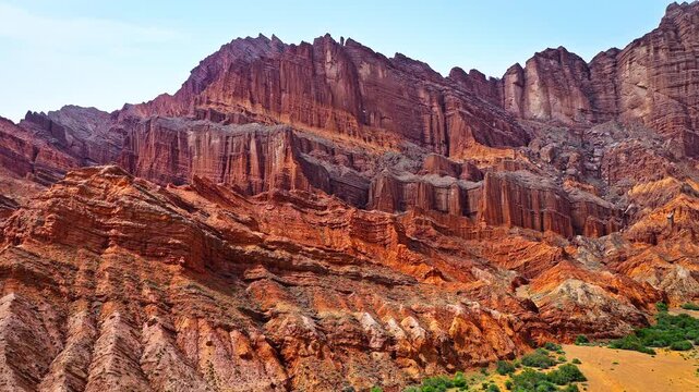 Aerial view of dramatic red rock canyon cliffs with stratified sandstone layers in Kuqa, Xinjiang, China