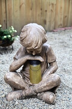 Boy with a firefly in a jar