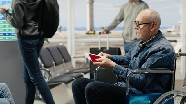Happy man with disability in airport lounge preparing for boarding flight, highlighting accessibility, inclusive tourism during golden years, breaking stereotypes and wheelchair user.