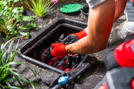 Worker connecting wires in an irrigation valve box
