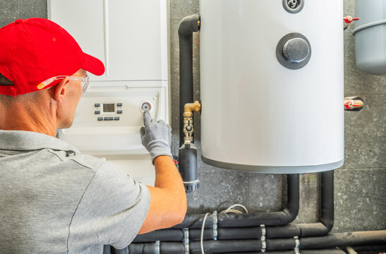 Technician checking a boiler pressure gauge