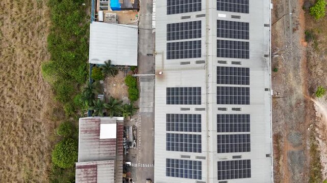Rows of solar panels installed on a large industrial warehouse roof in South Kalimantan Indonesia
