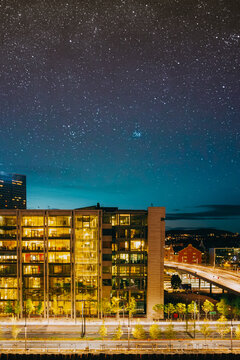 Stunning night panorama of the modern illuminated Barcode Project skyscrapers along Dronning Eufemias gate under a starry sky in Bjorvika, Oslo.