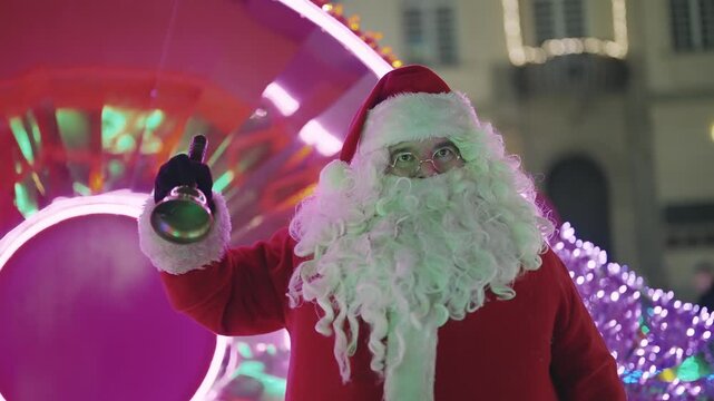 Santa Claus Ringing Bell Amidst Festive Christmas Lights in Warsaw