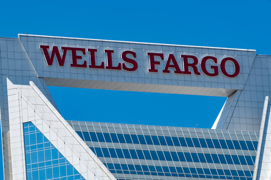 The top of the Wells Fargo building in uptown Charlotte, NC set against a deep blue sky