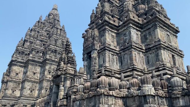 View of stone spire top architecture at Prambanan temple against clear blue sky, Yogyakarta, Central Java, Indonesia.
