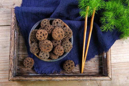 Dried Liquidambar Fruits on Ancient Chinese Paper Scroll
