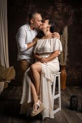 Loving couple sharing intimate kiss in studio