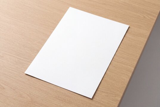 Blank white A4 paper mockup on a light wooden desk surface for corporate branding design
