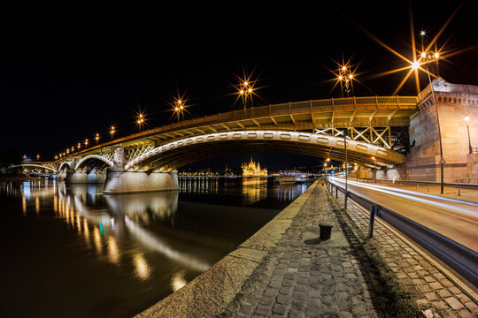 Beautiful night view of the illuminated Margaret Bridge (Margit hid) in Budapest with the Parliament building in the background