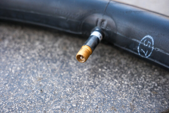 Schrader Valve on a Bicycle Inner Tube, Close-Up of Tire Inflation Valve, Cycling Maintenance Concept
