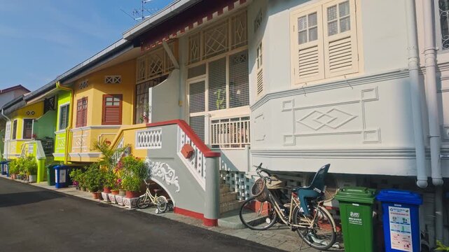 Joo Chiat hophouses With Vibrant Pastel Facades, Decorative Stairs, And Traditional Windows Along Residential Street In Katong, SIngapore. - pan shot