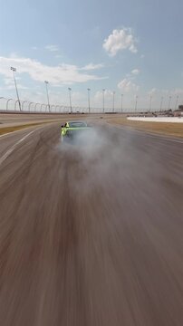 Hype: speed drone following a green drift car peeling around a curve with tire smoke