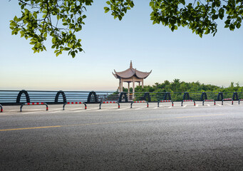 Tranquil View of a Pagoda Alongside a Scenic Coastal Road © evening_tao