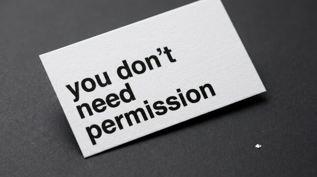 White paper card displaying bold black text message you dont need permission on dark gray background