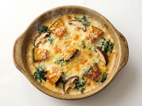 Delicious creamy vegetable curry with sliced mushrooms and fresh herbs served in a round rustic clay bowl. japanese gratin dish