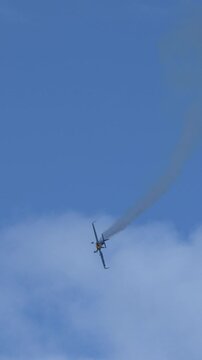 Aerobatic Stunt Plane Performing Aerial Dive Leaving Smoke Trail