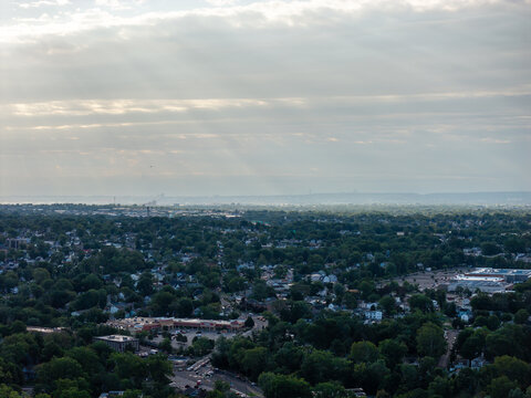 Panoramic view showing a wide urban cityscape, layered architecture, streets, rooftops and skyline beneath daylight clouds in a detailed high-angle travel composition with clear visual depth acros
